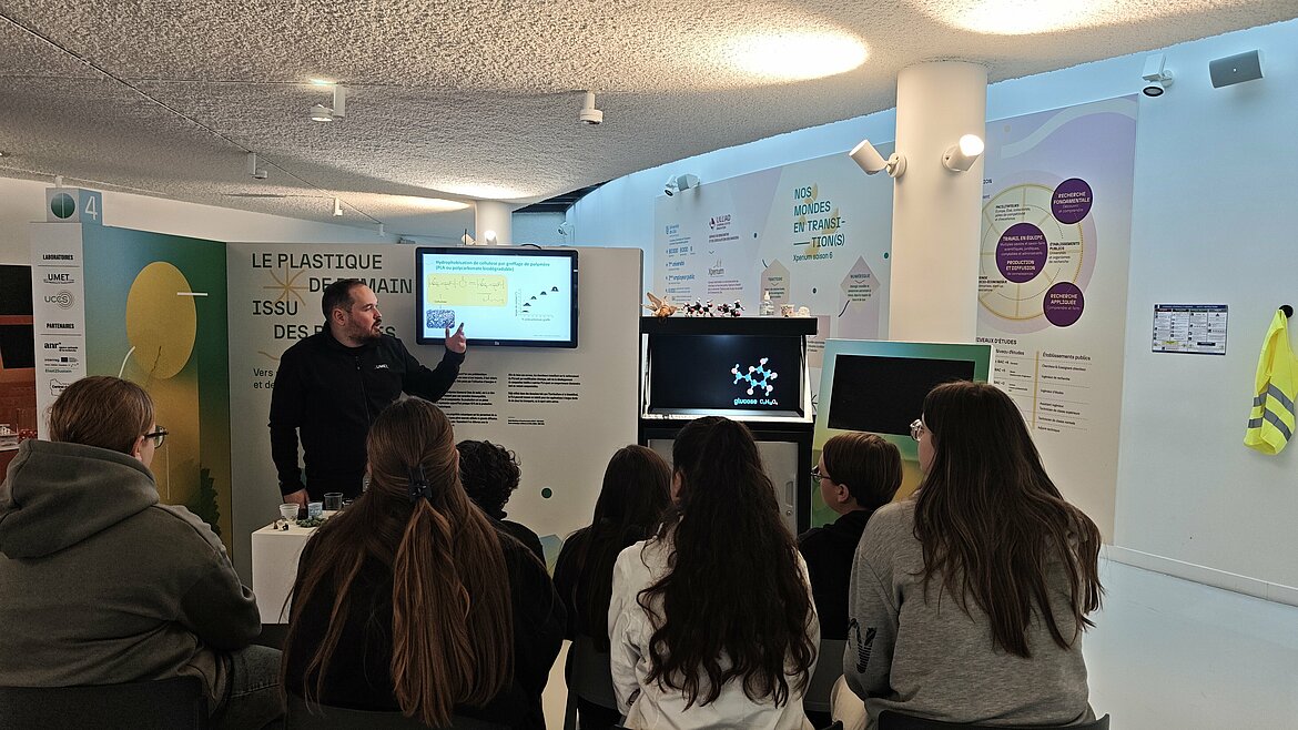 Photos of students in front of an Xperium booth presentation. Credit: Elisa Despretz